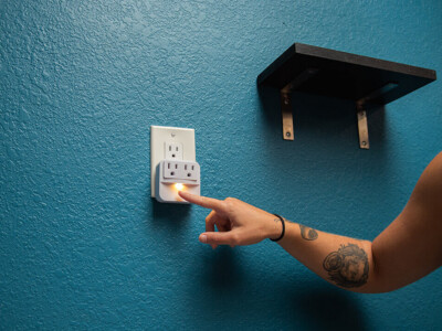 Personal power outlet and shelf beside a hostel bunk bed at California Dreams Hostel
