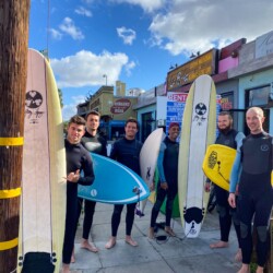 group-of-surfers-with-surfboards-outside-california-dreams-hostel-ocean-beach