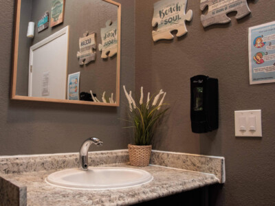 Clean bathroom sink with mirror at California Dreams Hostel in San Diego